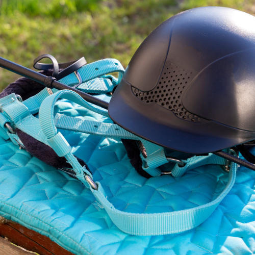 Top-quality UVEX riding helmet and Bucas Turnout rug with a riding crop on the side. Find all the horse equipment and accessories you need at McCaskie.store, your go-to source for premium equestrian gear. Visit us today!